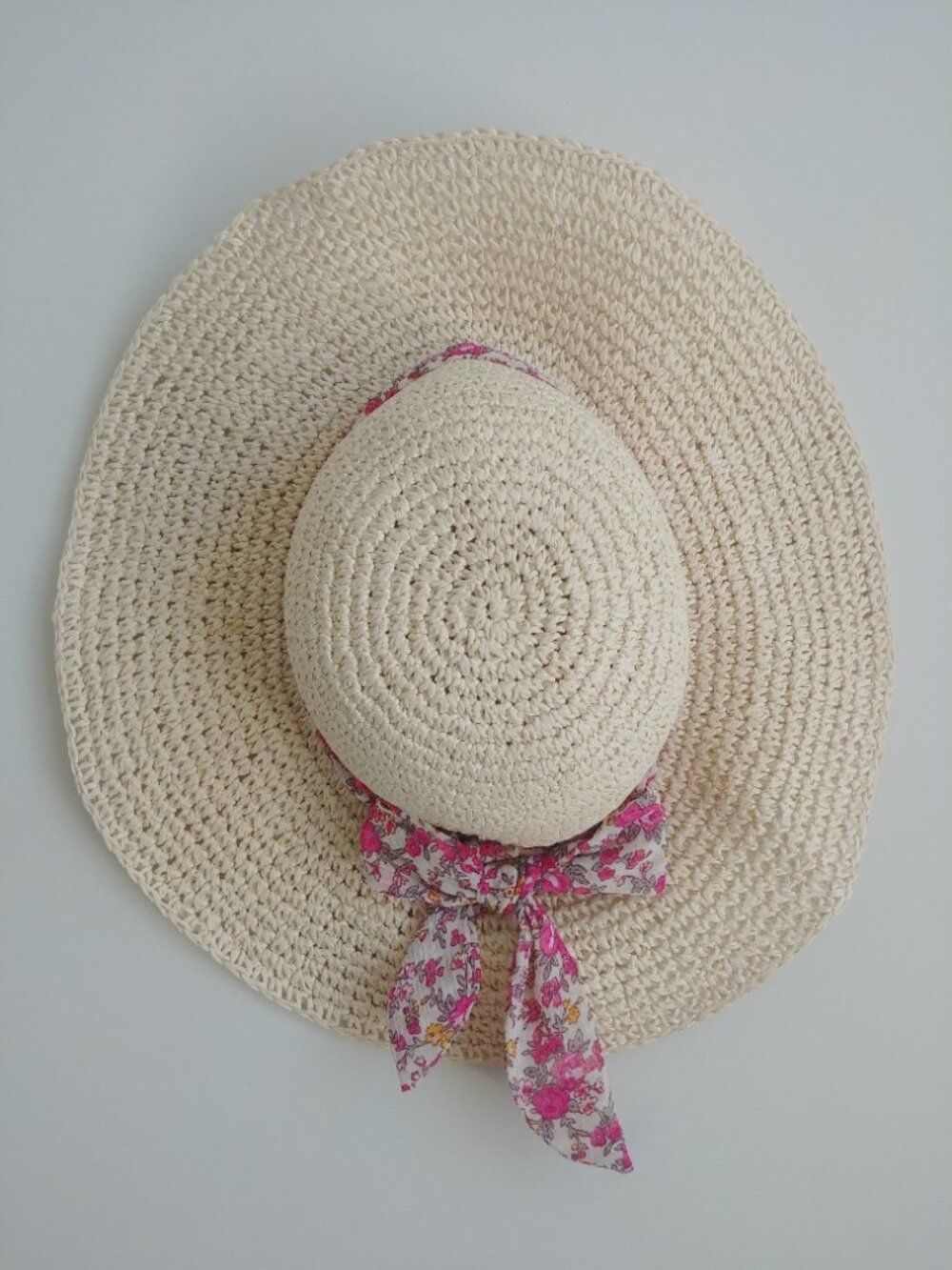 Pale tan cream straw paper floppy summer hat with pink floral bow and ribbon